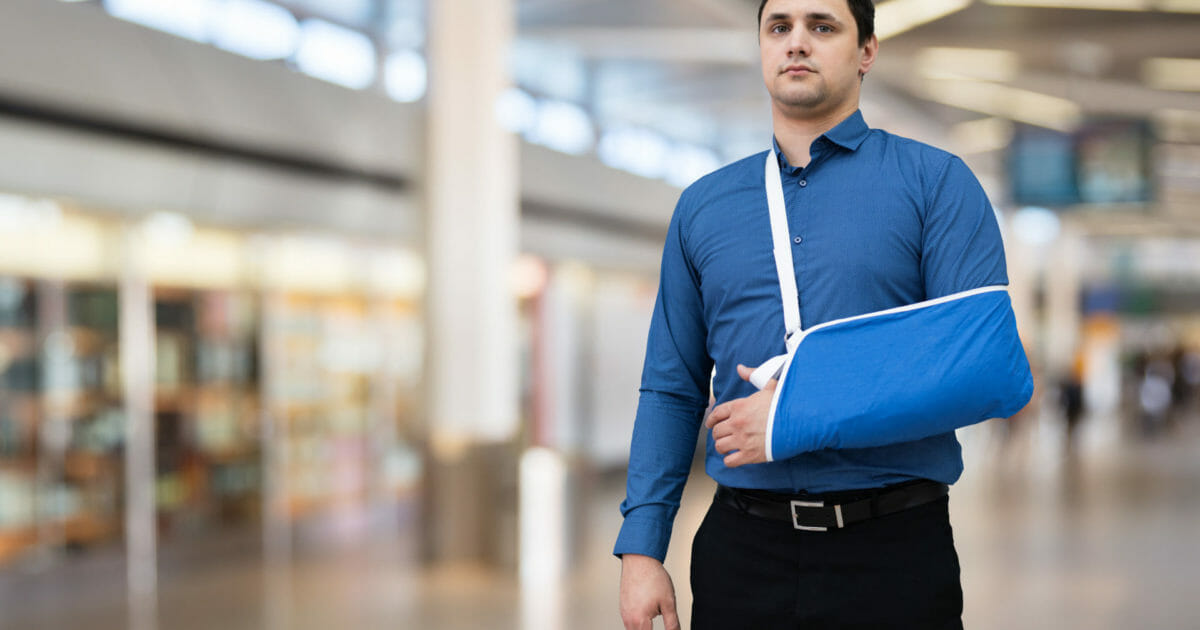Man With Broken Arm In Airport Terminal