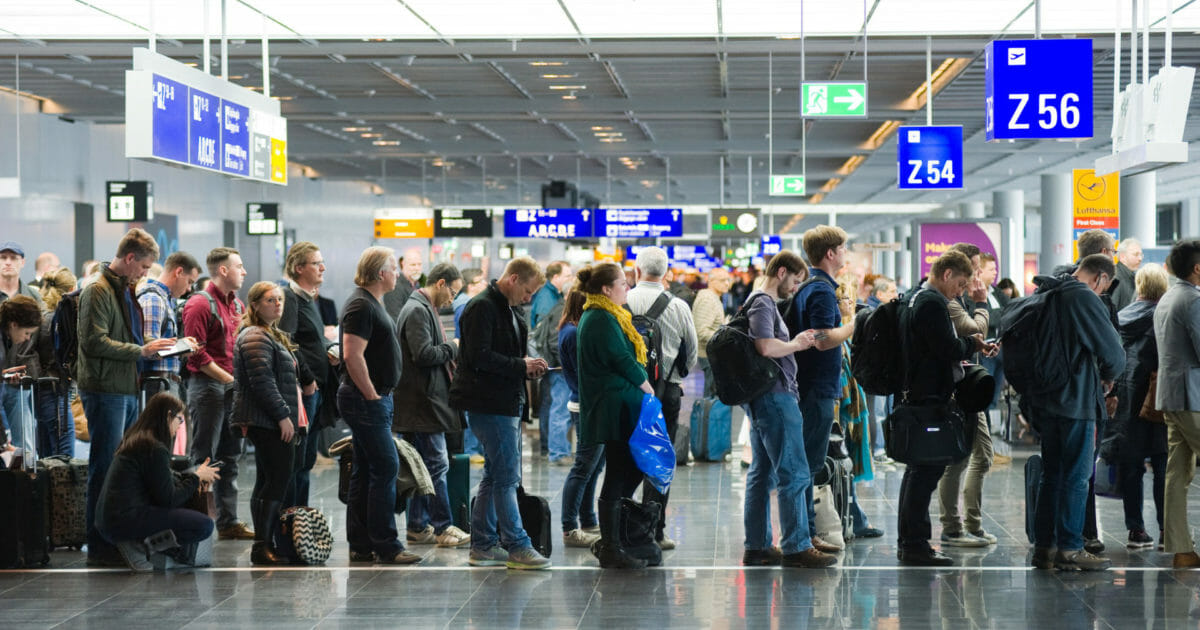 FRANKFURT, GERMANY - APRIL 25, 2016: Passengers waiting in a row for boarding on an airport to a flight to America